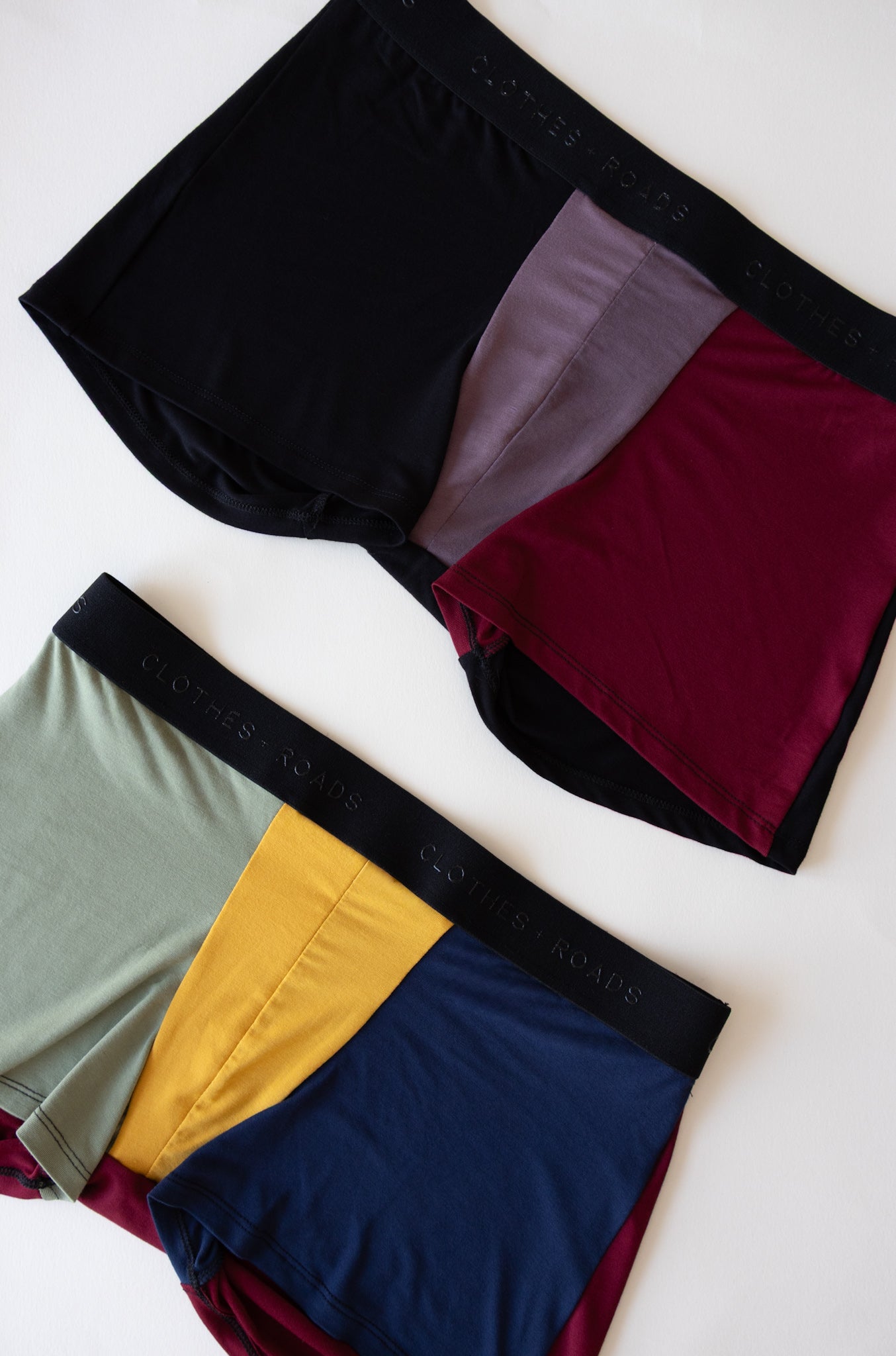 Two pairs of color-blocked men’s underwear on a white background