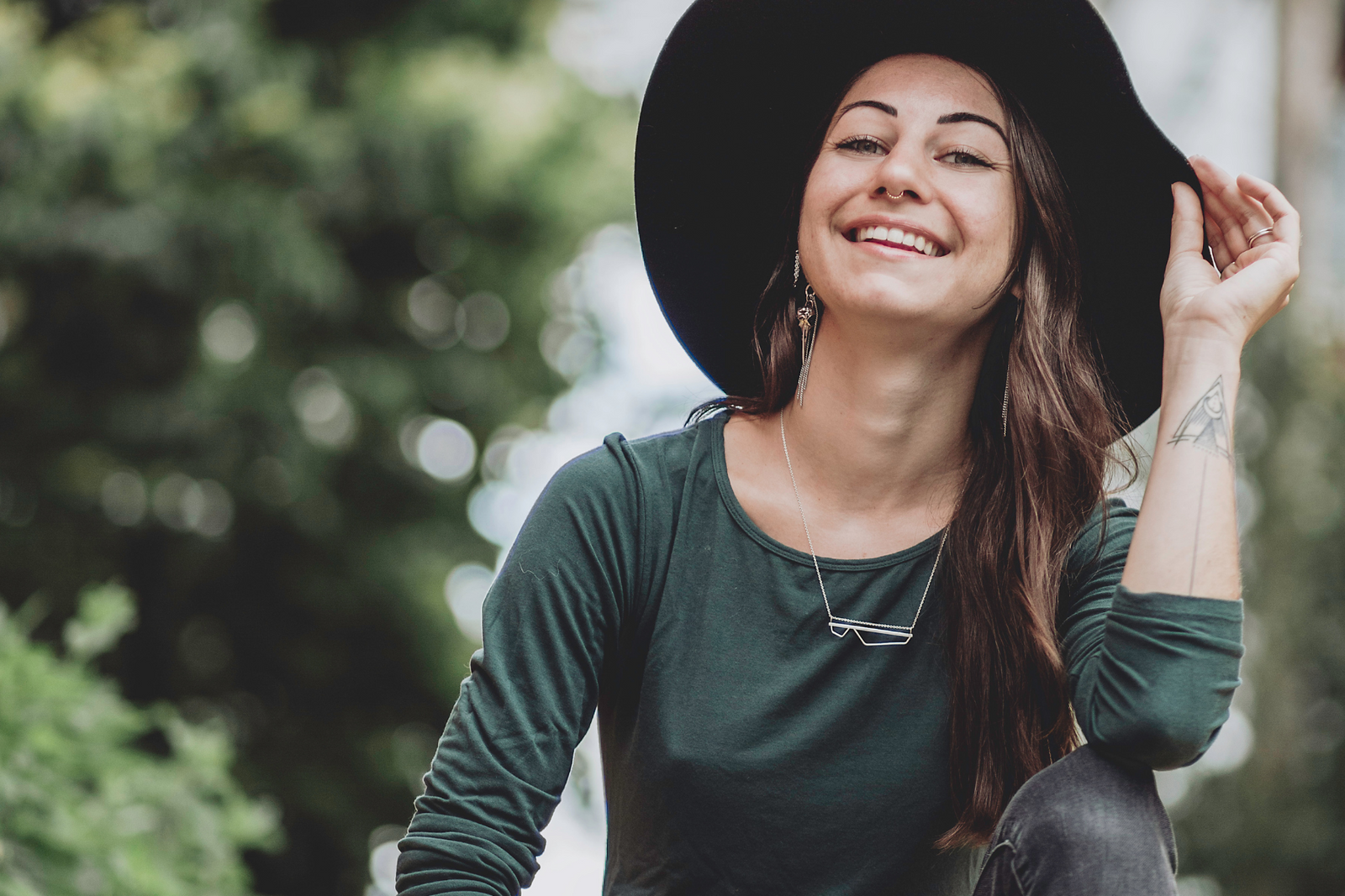 woman wearing green longsleeve shirt with black hat