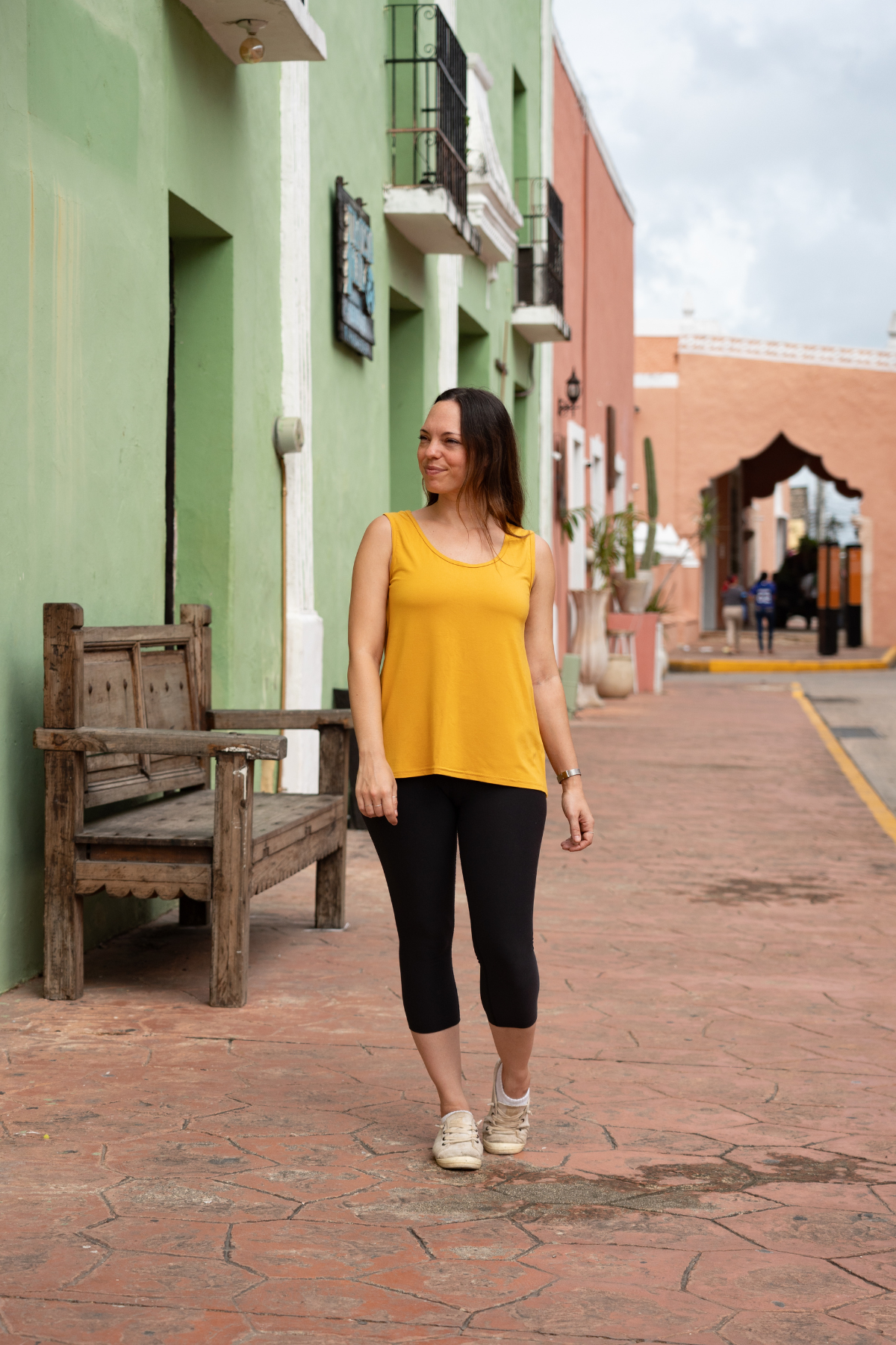 Woman wearing the sunflower yellow reversible bamboo camisole, front view.