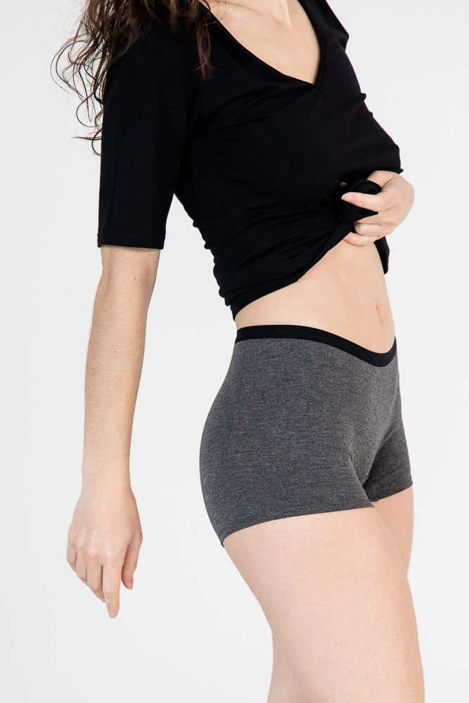 Woman wearing a soft grey bamboo boxer against a white background.