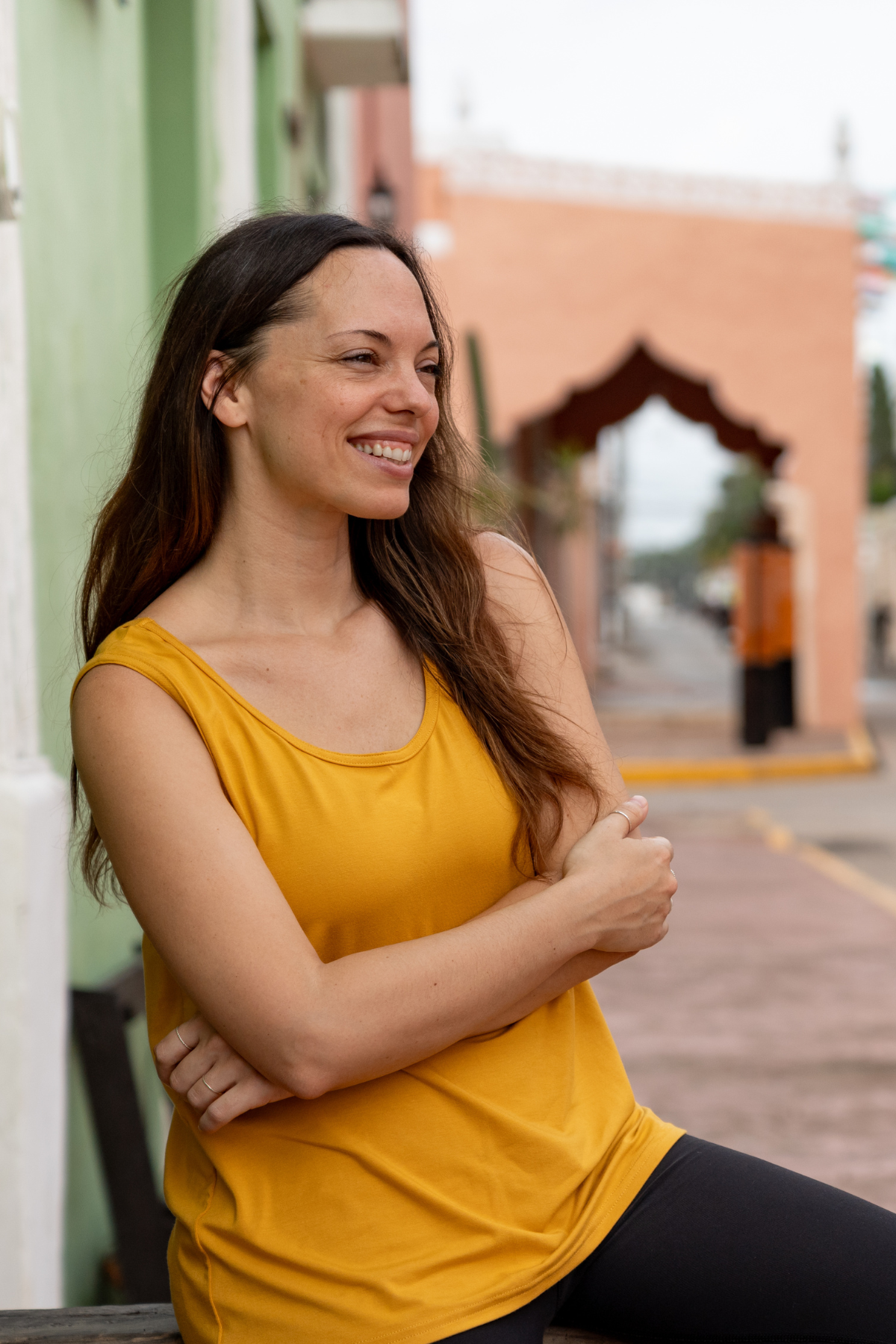 Close-up of woman wearing the sunflower yellow reversible bamboo camisole, front view with scoopneck.