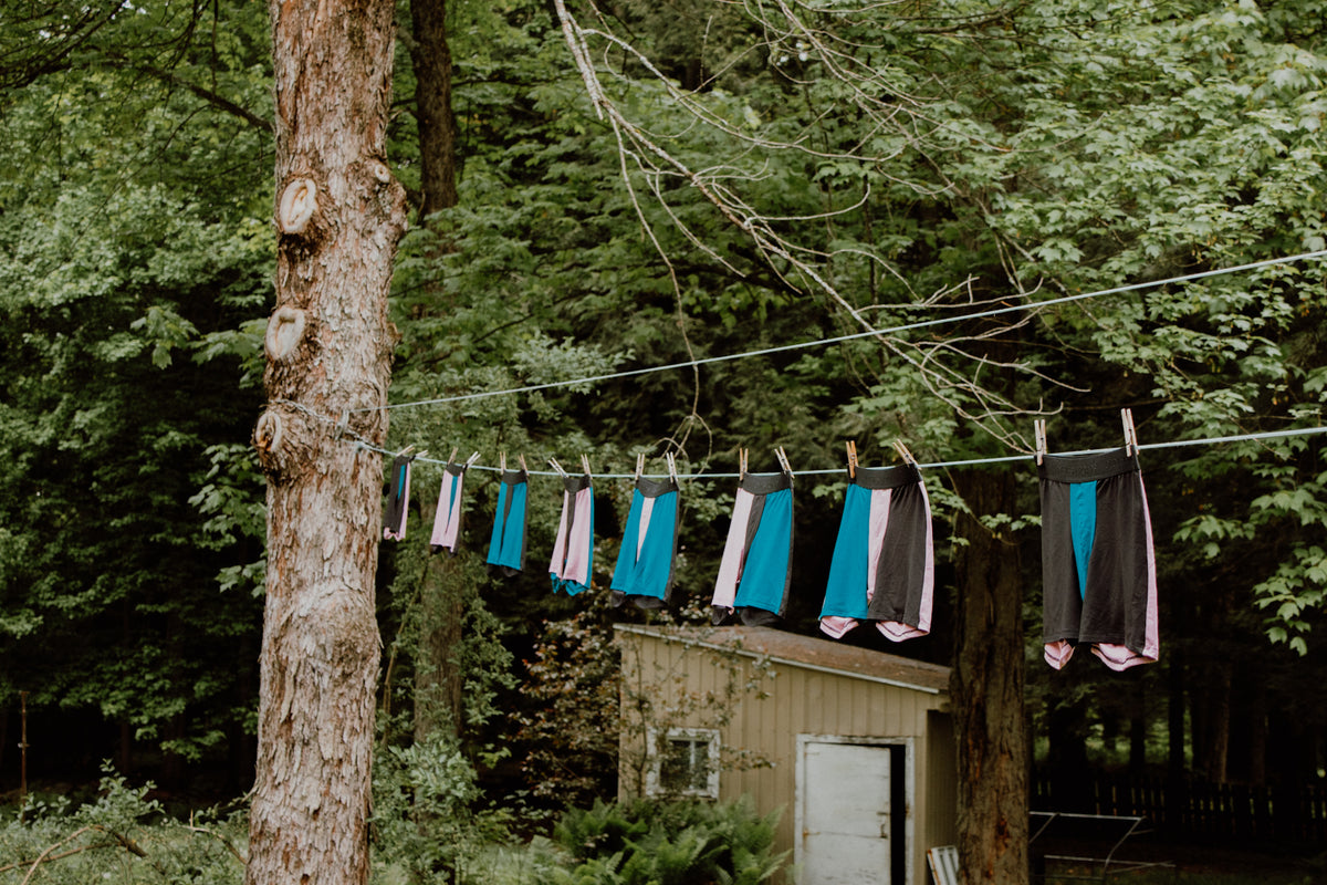 Men's boxers hanging on a clothesline in a forest setting