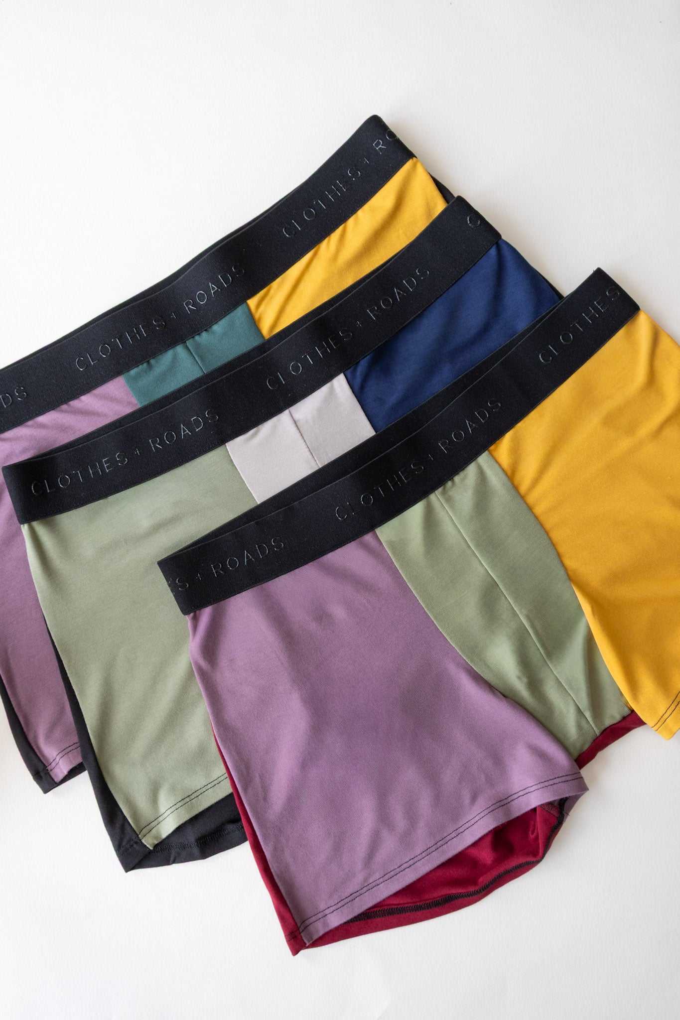 Set of colorful men's underwear with branded waistbands on a white background