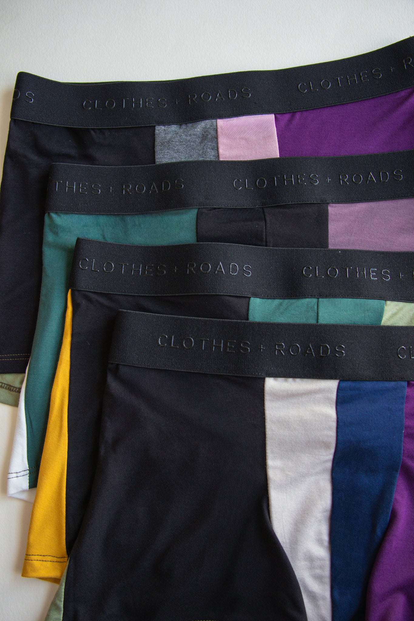 Colorful underwear with 'Clothes & Roads' branding on a white background